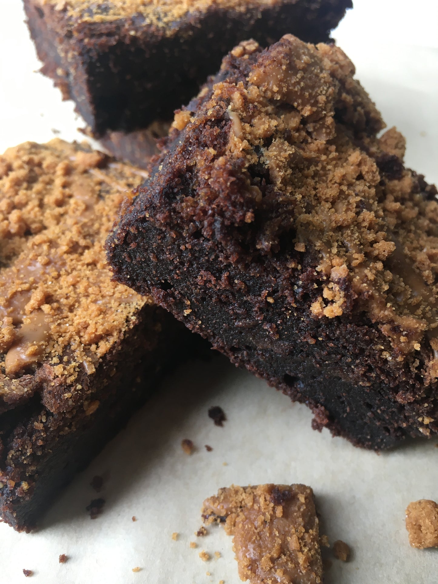 A decadent vegan Biscoff brownie, topped with swirls of creamy Biscoff frosting and crumbled Biscoff cookies.