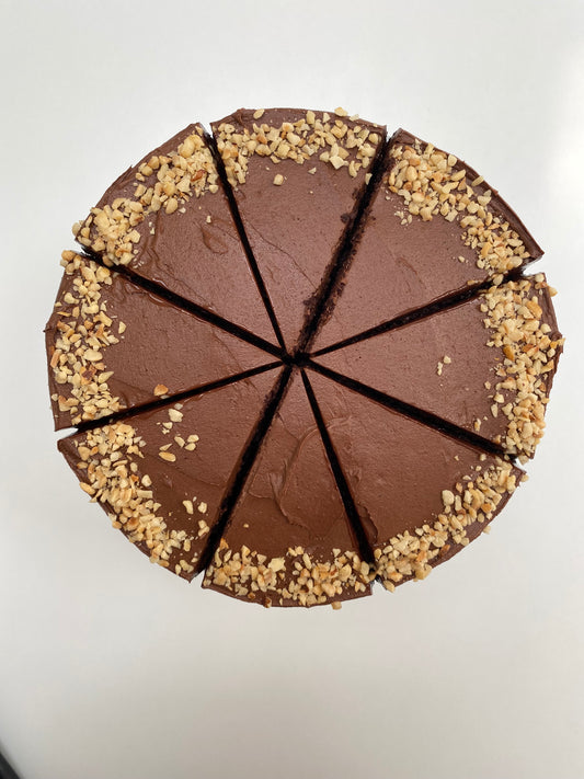 A decadent vegan chocolate cake with layers of rich, dark cocoa sponge and velvety chocolate frosting.