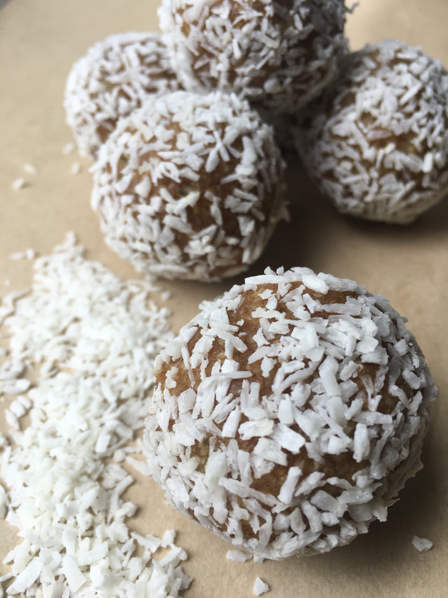 A tempting vegan Lemon Key Pie Energy Ball, its textured surface hinting at the zesty lemon and creamy filling within.